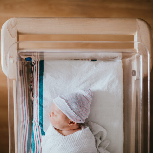 Newborn baby in hospital representing DEVENEY's work in the healthcare field.